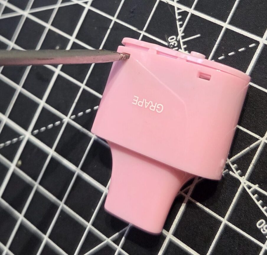 Lost Mary BM6000 Disposable Vape - Levering the top off of the plastic mouthpiece